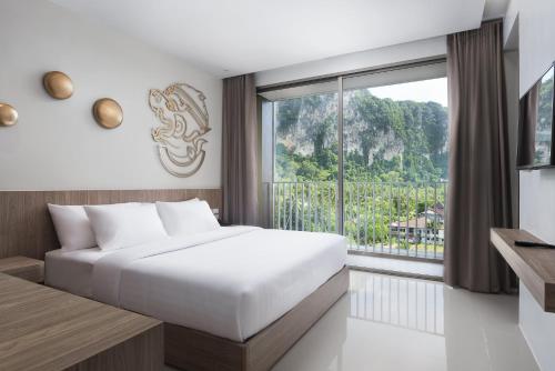 a bedroom with a bed and a large window at Centara Life Phu Pano Krabi-SHA Plus in Ao Nang Beach