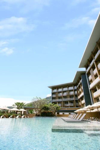 a resort with a swimming pool and a building at Centara Life Phu Pano Krabi-SHA Plus in Ao Nang Beach