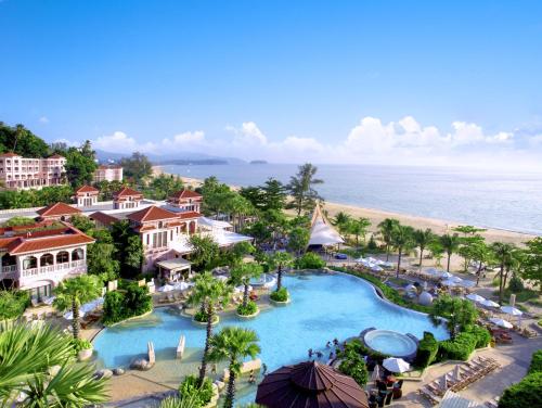 an aerial view of a resort with a pool and the beach at Centara Grand Beach Resort Phuket in Karon Beach