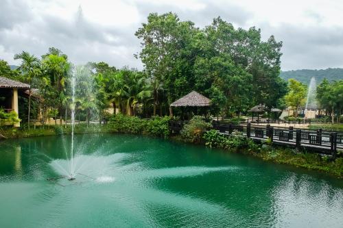 a fountain in a pond in a park at Centara Koh Chang Tropicana Resort in Ko Chang