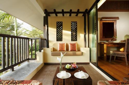 a living room with a couch and a table at Centara Koh Chang Tropicana Resort in Ko Chang