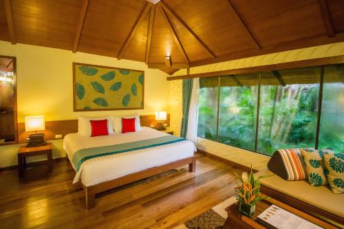 a bedroom with a bed and a large window at Centara Koh Chang Tropicana Resort in Ko Chang