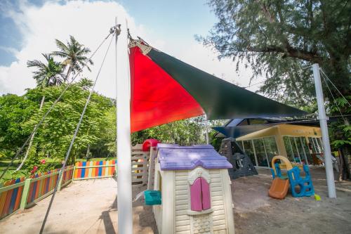 a playground with a tent and a toy house at Centara Koh Chang Tropicana Resort in Ko Chang