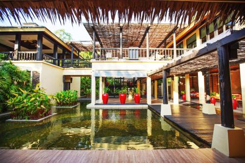 a courtyard of a building with a pool of water at Centara Koh Chang Tropicana Resort in Ko Chang