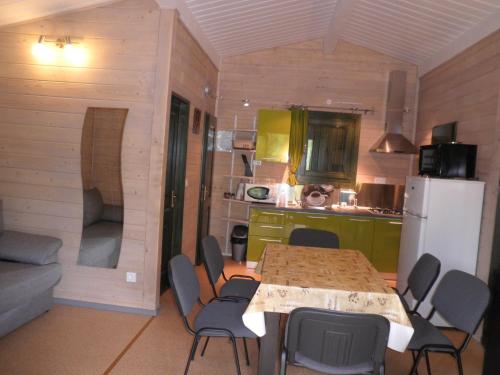 a kitchen with a table and chairs in a room at Chalet Confort Aloya in Ranspach