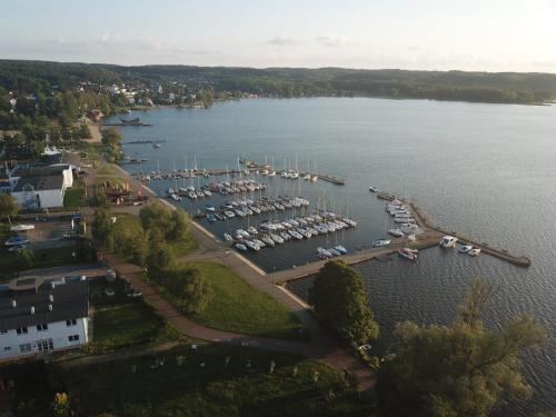 an aerial view of a marina with boats in the water at Nad Jeziorem in Charzykowy