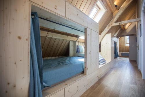 a room with a bed inside of a wooden house at Domaine de la Valaine in Étretat