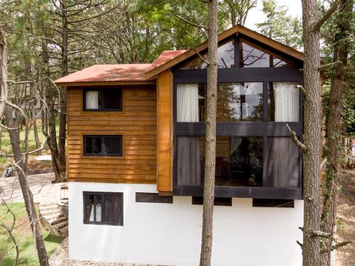 a house in the woods with a red roof at Hermosa Cabaña en Mazamitla a 1km del centro - Hermosa vista - Cómodas habitaciones - Todo cerca in Mazamitla