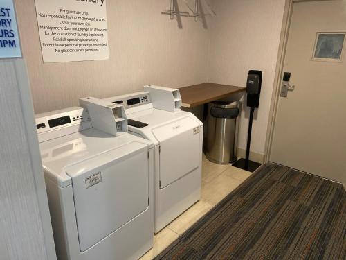 a laundry room with two washes and a table at Holiday Inn Express Atlanta-Stone Mountain by IHG in Stone Mountain