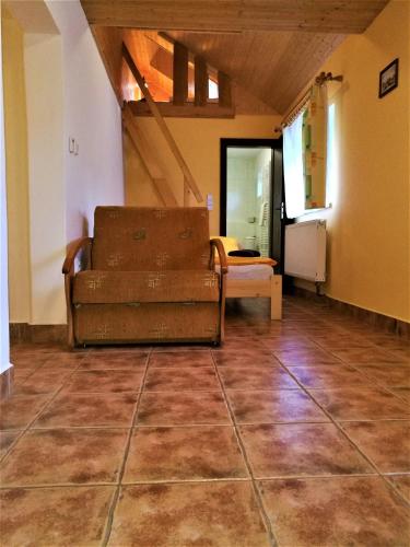 a living room with a couch sitting on a tile floor at Family apartments V Zátiší in Dolní Morava
