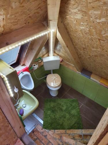 an attic bathroom with a sink and a toilet at Holiday Home Nature Neno in Visoko