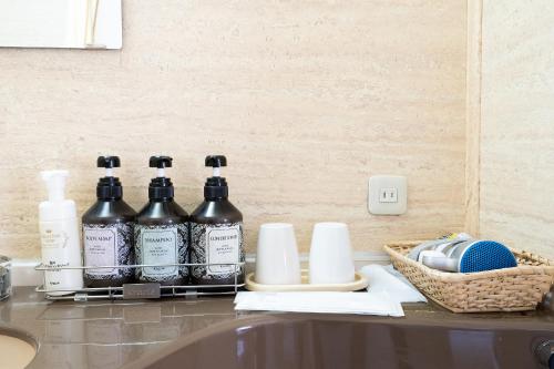 a counter with four bottles of alcohol on it at Tabist Hotel Mercury Asakusabashi in Tokyo