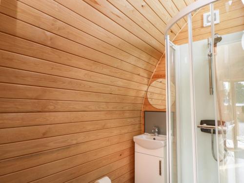a bathroom with wooden walls and a toilet and a sink at Halmore Pod in Berkeley