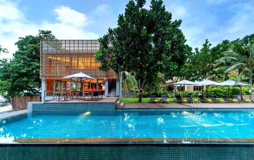 a large swimming pool in front of a building at Centara Q Resort Rayong in Mae Pim