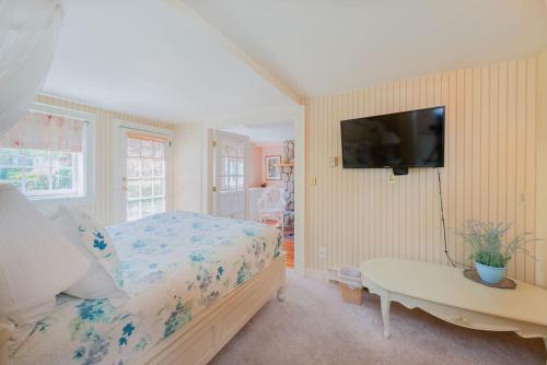 a bedroom with a bed and a tv on a wall at Beaconsfield Bed and Breakfast - Victoria in Victoria