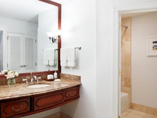 a bathroom with a sink and a mirror at The Tides Inn in West Irvington