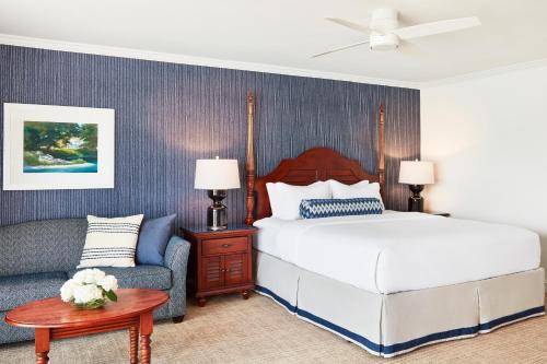 a bedroom with a bed and a couch at The Tides Inn in West Irvington