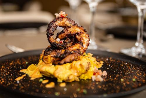 a plate of food with shrimp on top of it at Hotel York Luxury Suites Medellin by Preferred in Medellín