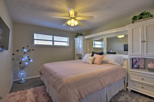 a bedroom with a bed with a ceiling fan at Eclectic Escape with Pool Walk to Ormond Beach in Ormond Beach
