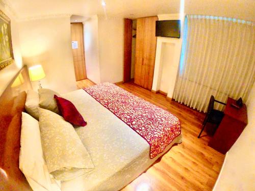 a bedroom with a large bed in a room at Hotel Casa Mahanaim Colferias, Bogotá in Bogotá