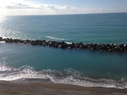 a group of rocks in the water on the beach at Hotel San Pietro Chiavari in Chiavari