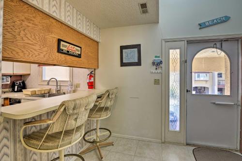 a kitchen with a counter and two bar stools at Townhome with Balcony Less Than 1 Mi to Wildwood Crest BCH! in Wildwood Crest