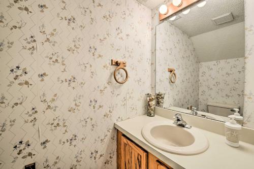 a bathroom with a sink and a clock on the wall at Townhome with Balcony Less Than 1 Mi to Wildwood Crest BCH! in Wildwood Crest