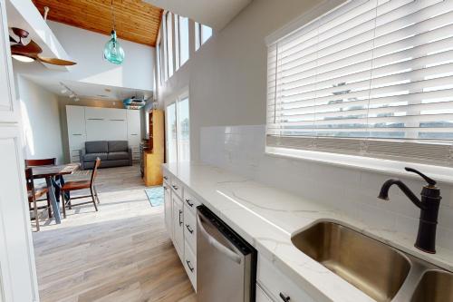 a kitchen with a sink and a counter top at Taylor's Perch in Galveston