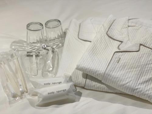 a white table with a shirt and glasses on it at Santiago Hotel in Hiroshima