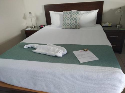 a hotel room with a bed with a towel on it at Bugambilias Suites in Loreto