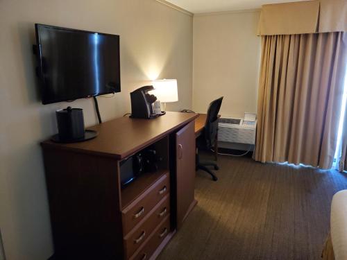 a hotel room with a desk with a television on it at Best Western The Westerly Hotel in Courtenay