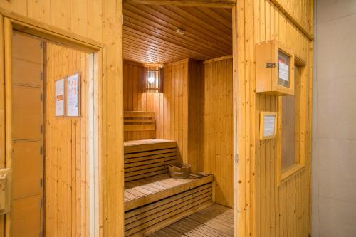 a wooden room with a sauna with a door at Altera Hotel and Residence by At Mind in Pattaya Central