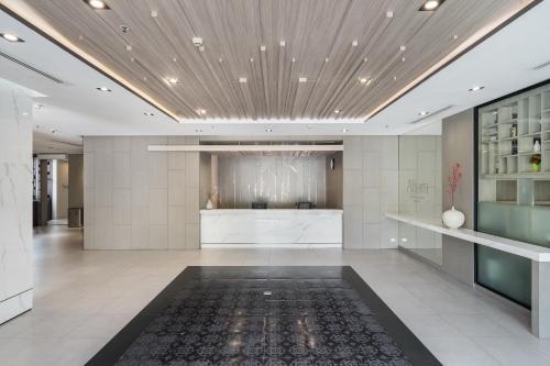a large room with a lobby with a rug at Altera Hotel and Residence by At Mind in Pattaya Central