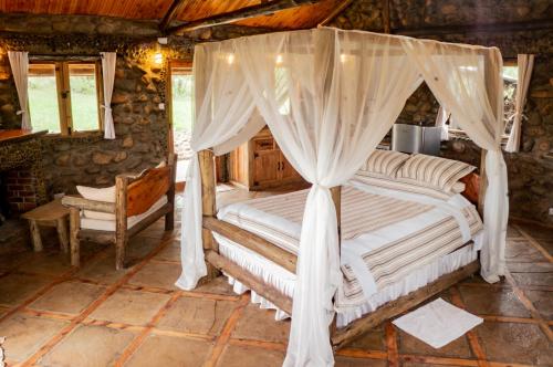 a bedroom with a bed with a canopy at Honeymoon Hut in Naivasha