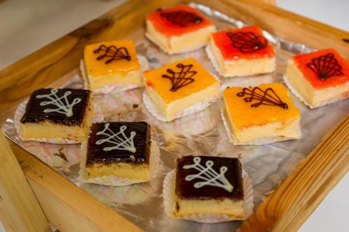 a tray filled with different types of cakes at Altera Hotel and Residence by At Mind in Pattaya Central