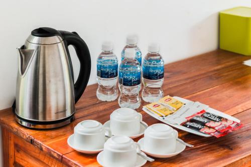 a table with a coffee pot and bottles of water at Prek Kdat Resort in Kampot