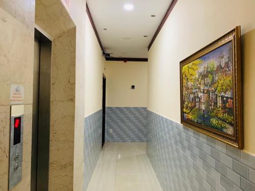 a painting hanging on a wall in a hallway at Mekong Rose Hotel in Can Tho