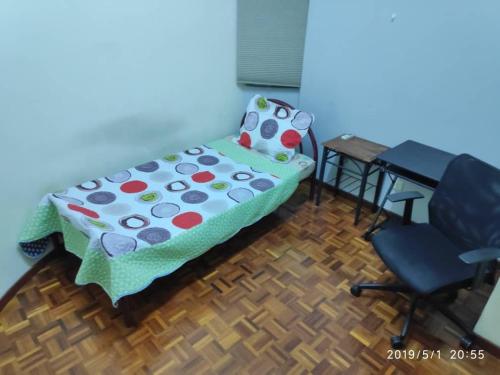 a bedroom with a bed and a desk and a chair at Villa Putra PWTC R3 Single Room in Kuala Lumpur