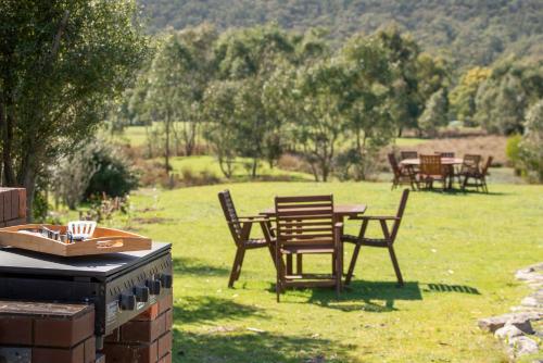 a group of tables and chairs in a field at Halls Gap Motel in Halls Gap