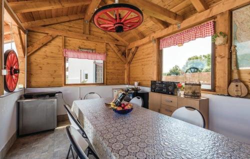 a kitchen with a table and chairs in a cabin at Vila NINA in Gospić