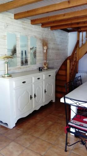 a white cabinet in a room with a staircase at Maison d'hôtes le clos de la Presle, Compostelle in Saint-Georges-Haute-Ville
