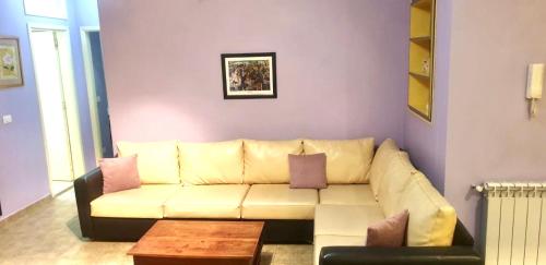 sala de estar con sofá blanco y mesa en Stone Chalets, en Fārayyā