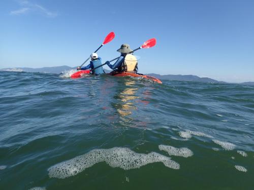 two people in a kayak in the ocean at Pension KUROSHIOMARU in Setouchi