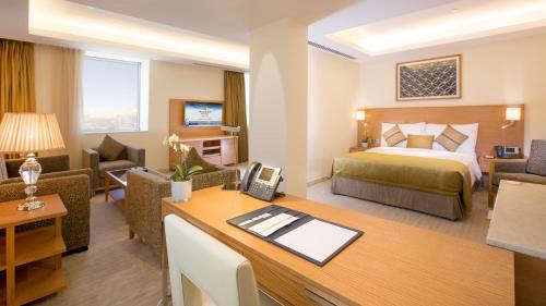a hotel room with a bed and a desk at Millennium Kurdistan Hotel & Spa in As Sulaymānīyah