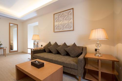 a living room with a couch and a table at Millennium Kurdistan Hotel & Spa in As Sulaymānīyah