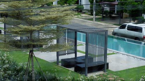a metal structure sitting next to a swimming pool at The Midst by The M - Nakhon Nayok TMD4 in Ban Som Phung Haeng (1)