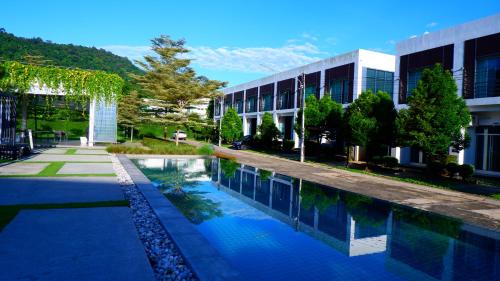 a swimming pool in front of a building at The Midst by The M - Nakhon Nayok TMD4 in Ban Som Phung Haeng (1)