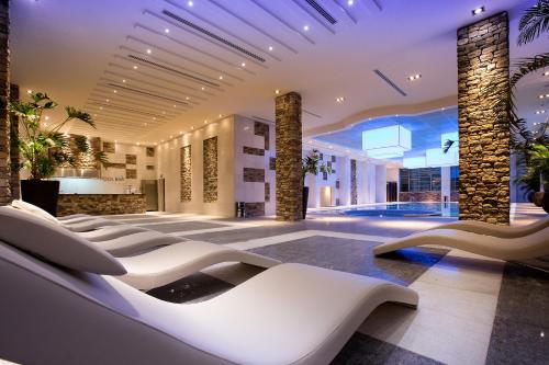 a hotel lobby with a row of white chairs at Millennium Kurdistan Hotel & Spa in As Sulaymānīyah