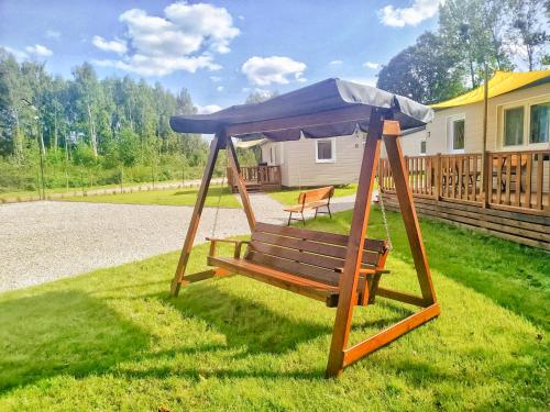 a swing with a blue canopy in a yard at LUXURY CAMP - 150 m od Suntago Park in Grabce-Towarzystwo