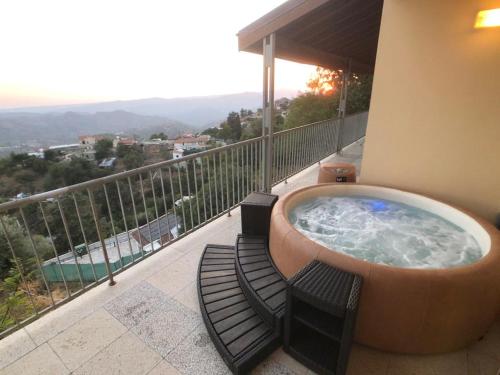 a hot tub on the balcony of a building at Retreat Centre Cyprus in Zoopiyi